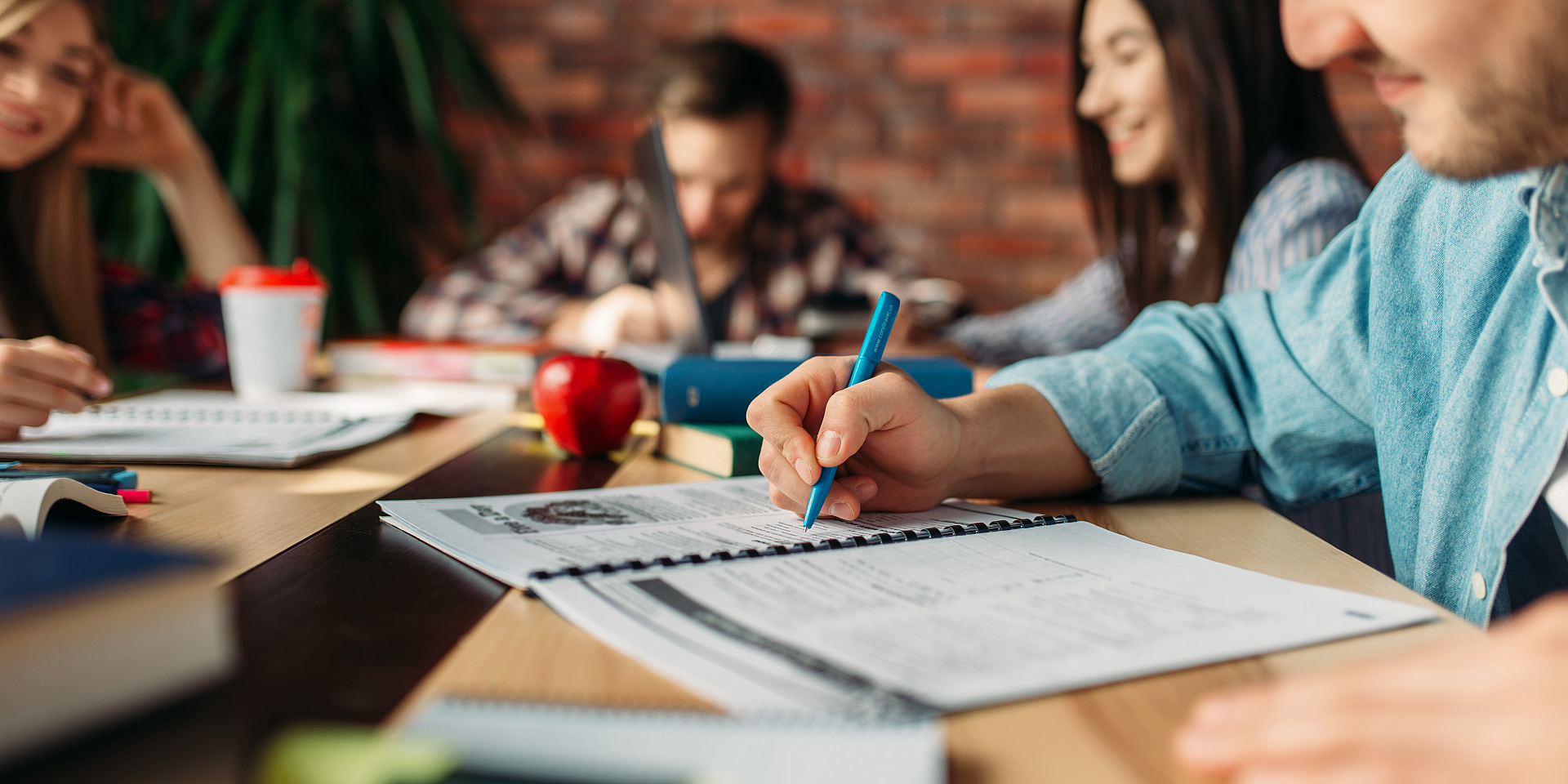 group-of-students-studying-at-the-table-7ASK9RN.jpg